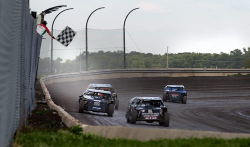 Race cars careen around a dirt track toward the checkered flag at Red River Speedway's Monday night races. See  story. July 27, 2015 - (Phil Hossack / Winnipeg Free Press)