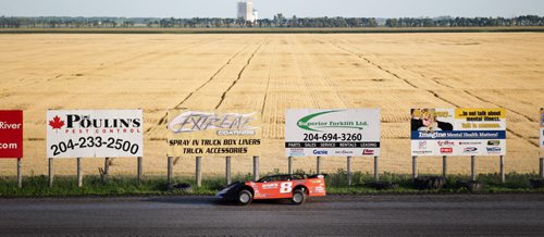 Race cars scream around a dirt track next to a ripening field of wheat at Red River Speedway's Monday night races. See  story. July 27, 2015 - (Phil Hossack / Winnipeg Free Press)