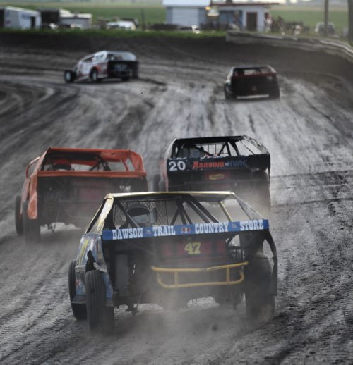 Race cars careen around a dirt track next to a ripening field of wheat at Red River Speedway's Monday night races. See  story. July 27, 2015 - (Phil Hossack / Winnipeg Free Press)