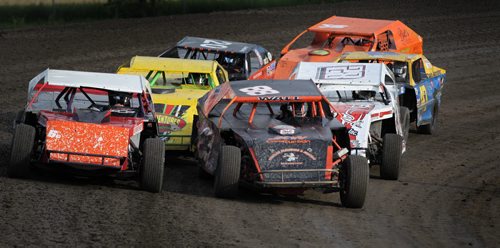 Race cars careen around a dirt track at Red River Speedway's Monday night races. See  story. July 27, 2015 - (Phil Hossack / Winnipeg Free Press)