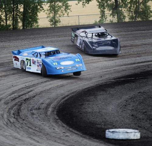 One wheel in the air a pair of Race cars careen around a dirt track at Red River Speedway's Monday night races. See  story. July 27, 2015 - (Phil Hossack / Winnipeg Free Press)
