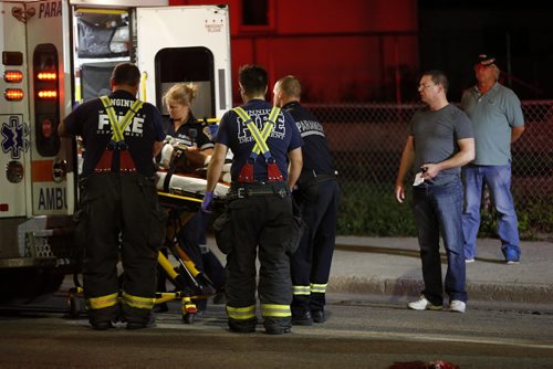 July 28, 2015 - 150728  -  The driver (L) and his passenger look on as a pedestrian hit by an east bound car is attended to on Selkirk Avenue Tuesday, July 28, 2015. John Woods / Winnipeg Free Press