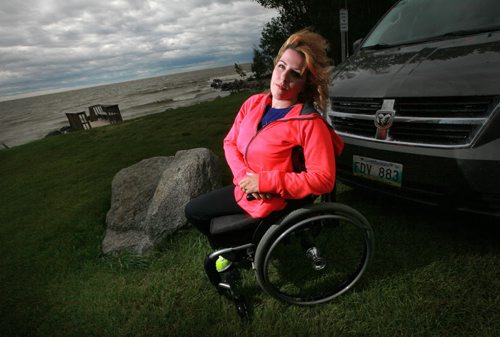 Janis Ollson poses near her cottage beside Lake Winnipeg. Victoria Beach will not allow the handicapped woman vehicle access to their beach for her kid's swimming lessons. See Carol Sanders story. July 29, 2015 - (Phil Hossack / Winnipeg Free Press)
