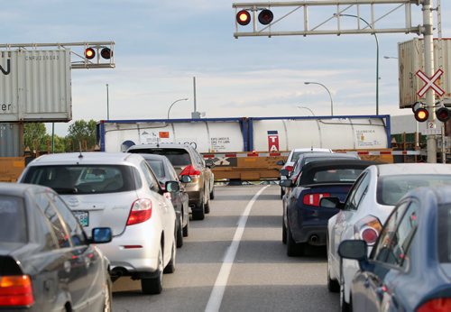Waiting for a train to cross at Waverley and Taylor Ave Thursday morningToday three levels of government will announce the Waverley St underpass construction project-See story- July 30, 2015   (JOE BRYKSA / WINNIPEG FREE PRESS)