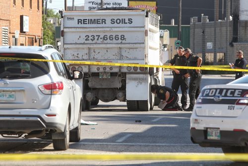 A female pedestrian died during this mornings rush hour as she crossed King St. at Logan Ave. when a large truck drove over her. Winnipeg police and emergency investigators are on the scene keeping Logan and King closed to traffic for the foreseeable future.  150730 July 30, 2015 MIKE DEAL / WINNIPEG FREE PRESS