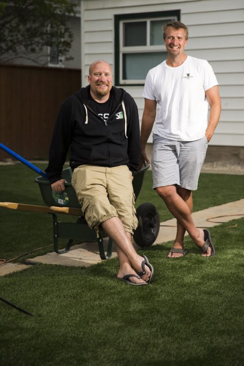 Dave Anhill (left) and Marlowe Friesen, co-owners of Synthetic Grass Winnipeg, stand in a yard that they've recently redone in Winnipeg on Thursday, July 30, 2015.  Mikaela MacKenzie / Winnipeg Free Press