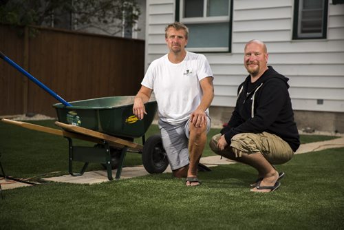 Marlowe Friesen (left) and Dave Anhill, co-owners of Synthetic Grass Winnipeg, stand in a yard that they've recently redone in Winnipeg on Thursday, July 30, 2015.  Mikaela MacKenzie / Winnipeg Free Press