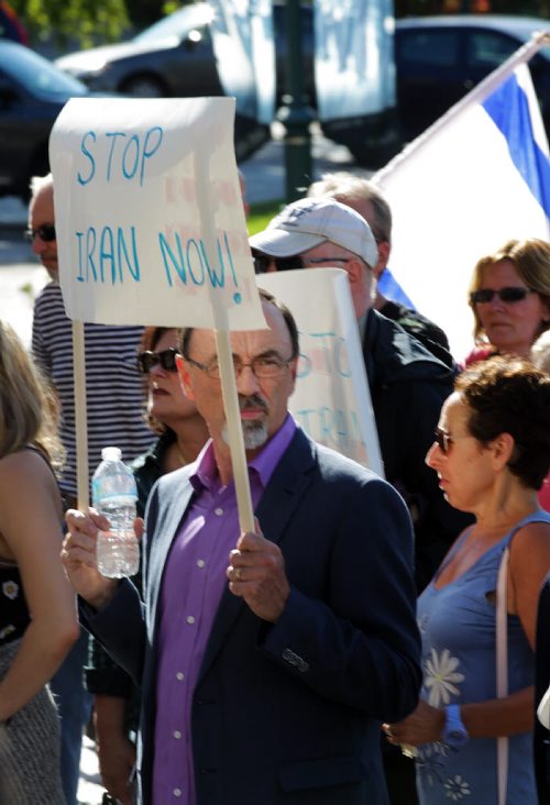 A protestor at the Mb Legislature Thursday holds up a small sign of support for the Winnipeg Friends of Isreal at a rally against the US Deal with Iran. See story / Release. July 30, 2015 - (Phil Hossack / Winnipeg Free Press)
