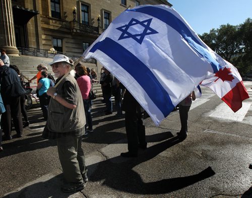 A protestors wave flags in support of the  sign of support for the Winnipeg Friends of Isreal at a rally against the US Deal with Iran. See story / Release. July 30, 2015 - (Phil Hossack / Winnipeg Free Press)