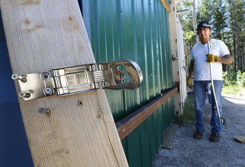 Lee Gott with parts of the storage shed door lock and handle thieves damaged while breaking in and stealing an ATV and a side by side utility vehicle from the shed on the  Ozhkiimaajaawin New Beginnings Cultural Ceremonial Grounds.  Alex Paul  story Wayne Glowacki / Winnipeg Free Press July 30 2015