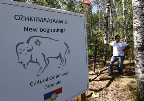 Lee Gott with the repaired section of the fence near the gate of the  Ozhkiimaajaawin New Beginnings Cultural Ceremonial Grounds after thieves broke in last weekend.  Alex Paul  story Wayne Glowacki / Winnipeg Free Press July 30 2015