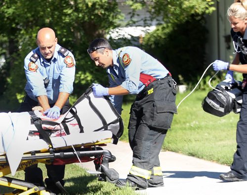 EMS  and Fire Crews tend to a person who was reportedly shot in the 600 Block of Moncton Ave  No other details available at this time-Breaking News- July 31, 2015   (JOE BRYKSA / WINNIPEG FREE PRESS)