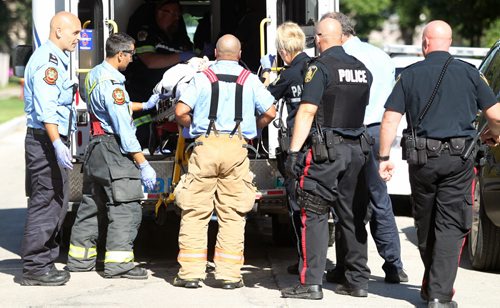 EMS  and Fire Crews tend to a person who was reportedly shot in the 600 Block of Moncton Ave  No other details available at this time-Breaking News- July 31, 2015   (JOE BRYKSA / WINNIPEG FREE PRESS)