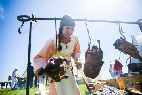 Heather Scott cooks ducks over a fire, re-enacting the viking way of life, at the Icelandic Festival in Gimli on Friday, July 31, 2015.  Mikaela MacKenzie / Winnipeg Free Press