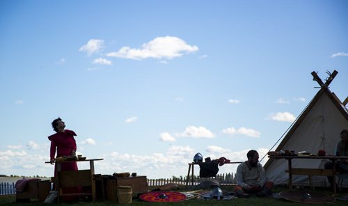 Cathy Dyck looks up at the sky as people reenact the viking way of life at the Icelandic Festival in Gimli on Friday, July 31, 2015.  Mikaela MacKenzie / Winnipeg Free Press