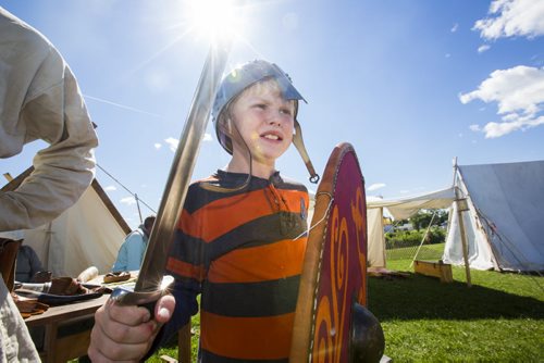 James Ansell, 10, makes a "viking face" while trying on battle gear at the Icelandic Festival in Gimli on Friday, July 31, 2015.  Mikaela MacKenzie / Winnipeg Free Press