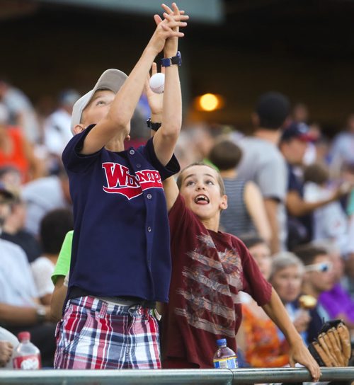 Justis Hellegards (left) and Easton DuBois try to catch a ball at a Winnipeg Goldeyes game versus the Amarillo Thundercats at Shaw Park in Winnipeg on Friday, July 31, 2015.  Mikaela MacKenzie / Winnipeg Free Press
