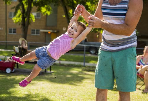 Claire Giesbrecht, 2, gets swung from side to side by her dad on a warm summer day in Winnipeg on Saturday, Aug. 1, 2015.  Mikaela MacKenzie / Winnipeg Free Press