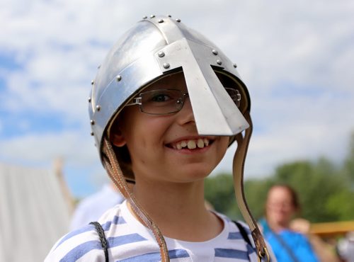 Sergey Nedelko, 9, tries on a helmet in the Viking Village at the Gimli Icelandic Festival, Saturday, August, 8, 2015. (TREVOR HAGAN/WINNIPEG FREE PRESS)