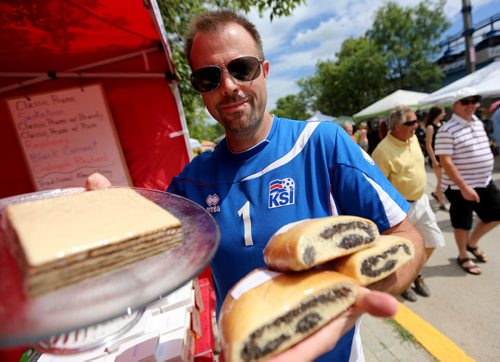 Kyle Robins serves up Vinarterta at the Gimli Icelandic Festival, Saturday, August, 8, 2015. (TREVOR HAGAN/WINNIPEG FREE PRESS)