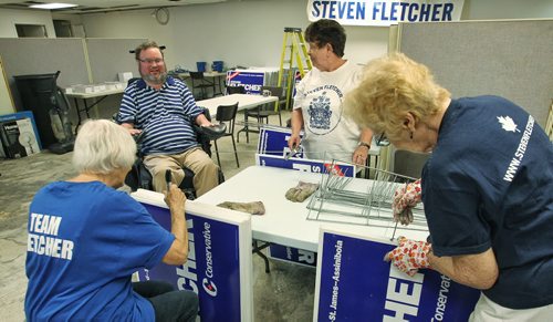 Incumbent MP Steven Fletcher chats with members of his sign making team Monday afternoon at his campaign office on Portage Ave. Sunday afternoon.  150803 August 03, 2015 MIKE DEAL / WINNIPEG FREE PRESS