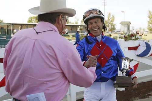 August 3, 2015 - 150803  -  Adolfo Morales riding Flashy Jewel celebrates with Flashy Jewel's trainer Clay Brinson after winning the 67th running of the Manitoba Derby at Assiniboia Downs Monday, August 3, 2015. John Woods / Winnipeg Free Press