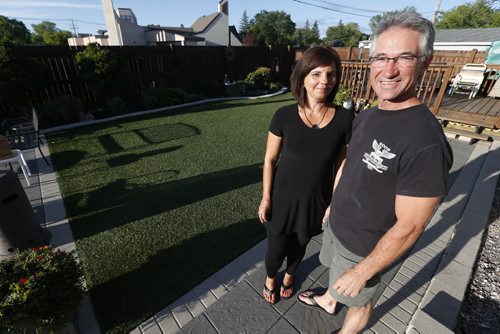 August 3, 2015 - 150803  -  Luc and Jackie Turenne are photographed in their artificially grassed backyard Monday, August 3, 2015. The Turennes have installed artificial grass to replace the natural stuff in their backyard. The natural grass was constantly worn away by their two dogs and the alternative is much more comfortable for Jackie's day care children.   John Woods / Winnipeg Free Press