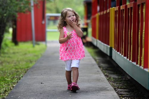 Two-year-old Maslyn Fast looks for her older brothers Slade and Kane to sit with before getting on the steam train with her family at the Assiniboine Park Tuesday.  The coal burning steam train, built in 1964, has been operating in the park for 51 years this summer.    Standup photo Aug 04,, 2015 Ruth Bonneville / Winnipeg Free Press