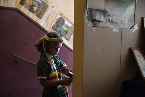 Hilina Yosef, 5, waits for visitors at the Ethiopian Folklorama pavilion in Winnipeg on Tuesday, Aug. 4, 2015.  Mikaela MacKenzie / Winnipeg Free Press