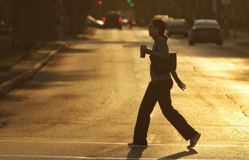 A pedestrian crosses Broadway at Osborne in the early morning light Wednesday. 150805 August 05, 2015 MIKE DEAL / WINNIPEG FREE PRESS