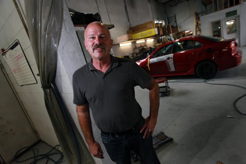 Moe Girard poses in his Transcona Autobody shop, he says the reason recycled auto parts is on the decline is because too many recyclers have been providing substandard parts to body shops. When this happens, body shops have no choice but to go with new parts.Geoff Kirbyson story.  August 5, 2015 - (Phil Hossack / Winnipeg Free Press)