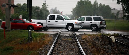 Marion ave traffic flows across a railway level crossing at Archibald Wednesday. See Aldo Santin story. August 5, 2015 - (Phil Hossack / Winnipeg Free Press)