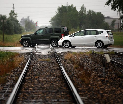 Marion ave traffic flows across a railway level crossing at Archibald Wednesday. See Aldo Santin story. August 5, 2015 - (Phil Hossack / Winnipeg Free Press)