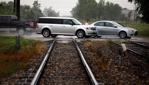 Marion ave traffic flows across a railway level crossing at Archibald Wednesday. See Aldo Santin story. August 5, 2015 - (Phil Hossack / Winnipeg Free Press)