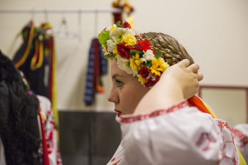 Breanna Slobik pins her flower headpiece in place before dancing at the Ukrainian pavilion of Folklorama in Winnipeg on Wednesday, Aug. 5, 2015.  Mikaela MacKenzie / Winnipeg Free Press