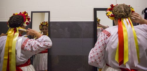 Daners pins her flower headpiece in place before performing at the Ukrainian pavilion of Folklorama in Winnipeg on Wednesday, Aug. 5, 2015.  Mikaela MacKenzie / Winnipeg Free Press