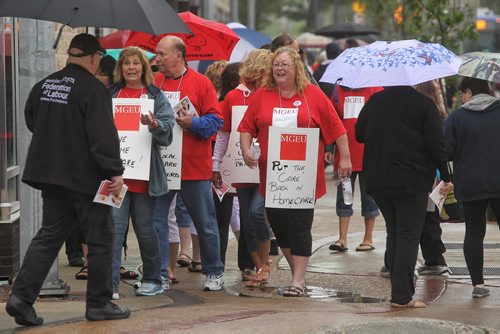 Around a hundred people gather to support homecare workers outside the WRHA offices on Main Street during a protest. Homecare workers are protesting having to work unpaid hours.  150806 August 06, 2015 MIKE DEAL / WINNIPEG FREE PRESS