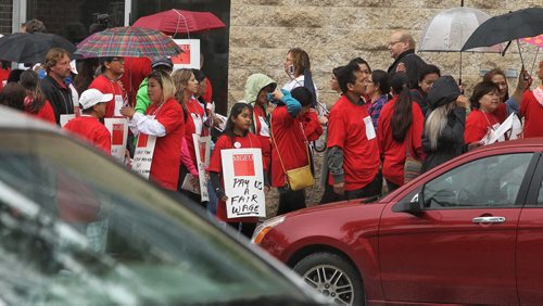 Around a hundred people gather to support homecare workers outside the WRHA offices on Main Street during a protest. Homecare workers are protesting having to work unpaid hours.  150806 August 06, 2015 MIKE DEAL / WINNIPEG FREE PRESS