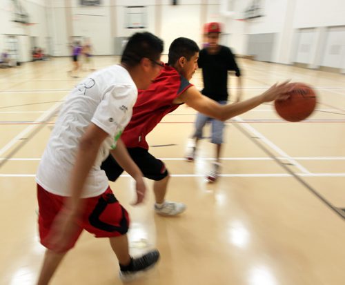 Carter Goosehead (left) scrimmages Thursday afternoon. He's the organizer of the Dufferin Youth basketball initiative and is helping organize a group of Dufferin neighbourhood youth who have organized several tournaments this summer. This photo is for Melissas sports Saturday Special. August 6, 2015 - (Phil Hossack / Winnipeg Free Press)