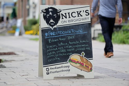 Sandwich sign for Nick's on Broadway, 287 Broadway.   What: This is for an Intersection feature on the Travelling Sign Painters  See Dave Sanderson story.   Aug 6, 2015 Ruth Bonneville / Winnipeg Free Press