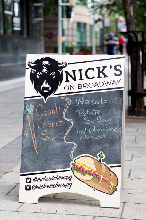 Sandwich sign for Nick's on Broadway, 287 Broadway.   What: This is for an Intersection feature on the Travelling Sign Painters  See Dave Sanderson story.   Aug 6, 2015 Ruth Bonneville / Winnipeg Free Press