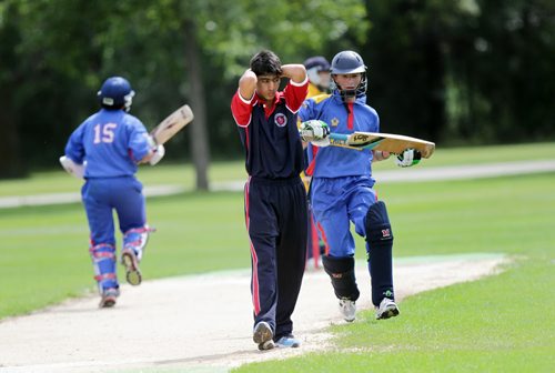 Combined Manitoba Quebec team Captain Inderjeet Parhar reacts to a bad bowl against team BC as the BC batteres run between the wickets Friday afternoon in the final day of the Cricket Canada U-16 Championships.  See Tim Campbell's story. August 7, 2015 - (Phil Hossack / Winnipeg Free Press)