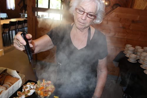 Dora Penner checks the steaming hot cabbage borscht at the Livery Barn Restaurant. BILL REDEKOP/WINNIPEG FREE PRESS July 31,  2015