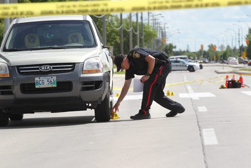 Police Officers investigate a pedestrian  accident involving an older woman crossing at a cross walk on St. Annes Rd. at Compark Saturday afternoon.  Vehicle in photo was involved in accident. No other information available at this time.   Aug 8, 2015 Ruth Bonneville / Winnipeg Free Press