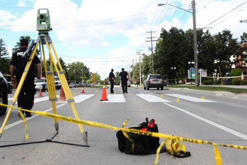 Police Officers investigate a pedestrian  accident involving an older woman crossing at a cross walk on St. Annes Rd. at Compark Saturday afternoon.   Aug 8, 2015 Ruth Bonneville / Winnipeg Free Press