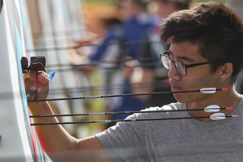 Paul Kim from Toronto adds up his points during an elimination round of the Canada Open at the Canadian Archery Championships in Winnipeg. Over two hundred competitors from across the country took part in the championship which finished Sunday.  150809 August 09, 2015 MIKE DEAL / WINNIPEG FREE PRESS