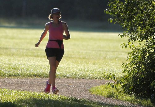 An unnamed jogger trots along Chirchill Drive Park near osborne. BORIS MINKEVICH/WINNIPEG FREE PRESS August 10, 2015
