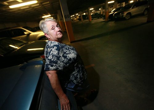 Christiane Leroux - grandmother who was knocked out with the butt end of a shotgun in a 2013 assault poses in the parking garage where she was found unconcious after thieves stole her car. See Mike MacIntyre story. August 10, 2015 - (Phil Hossack / Winnipeg Free Press)