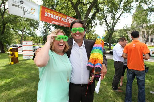 Downtown Winnipeg Biz Director Stefano Grande and city councillor Cindy Gilroy try on funky glasses on Broadway Tuesday at the end of a presser announcing the lineup of activities for this year's 5th annual ManyFest taking place Sept 11-13.     Aug 11, 2015 Ruth Bonneville / Winnipeg Free Press