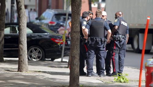 Police appear to do a sobriety test on a man on Albert Street near Old Market Square. They cuffed him and took him away. BORIS MINKEVICH / WINNIPEG FREE PRESS PHOTO August 11, 2015